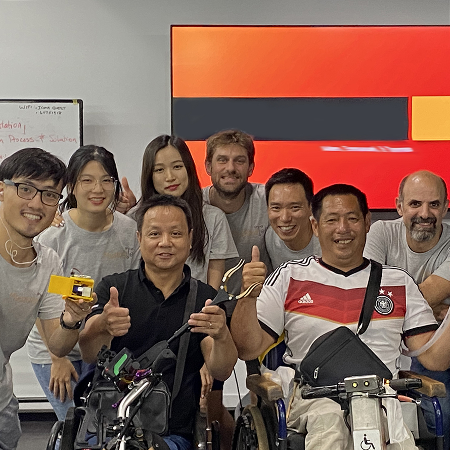 students with people with disabilities posing with projects in hand