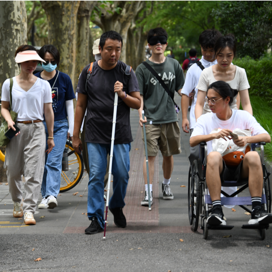 Empathy activity with people navigating the city in a wheelchair and white cane.